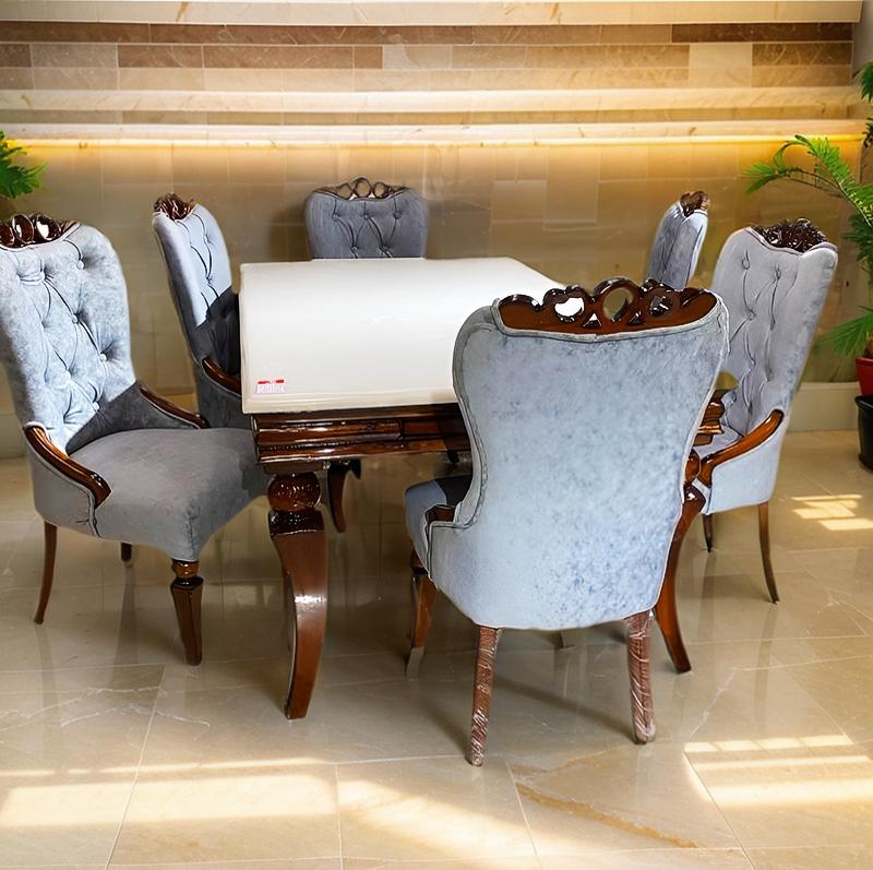 dining table set with onix top and upholstered chairs in teak wood frame